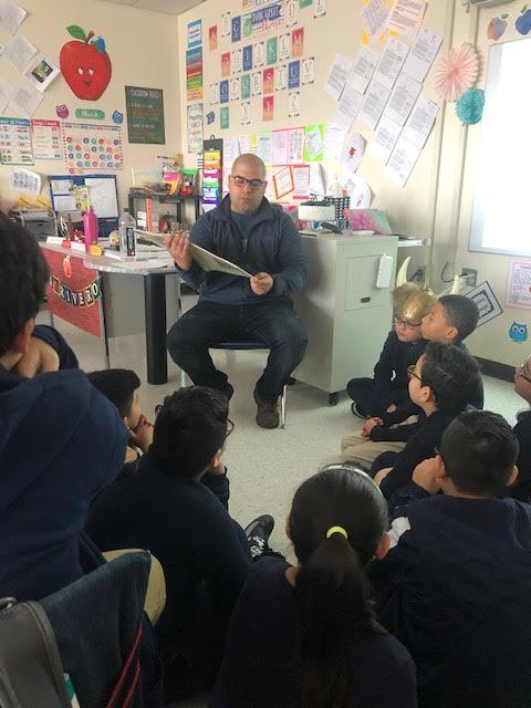 father reading to class