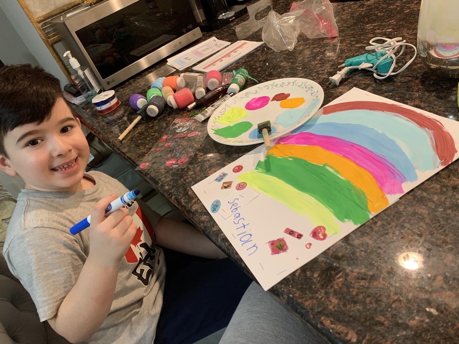 boy drawing rainbow